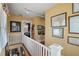 Second floor hallway with white railing and vintage decor at 1508 Delaney Ave, Orlando, FL 32806