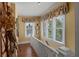 Upstairs hallway with hardwood floors, a window, and natural light creating an airy space at 1508 Delaney Ave, Orlando, FL 32806