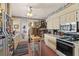 Classic kitchen featuring tile floors, white appliances, and a breakfast nook table at 1508 Delaney Ave, Orlando, FL 32806