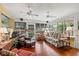 Bright sunroom with hardwood floors, ceiling fans, and an abundance of natural light at 1508 Delaney Ave, Orlando, FL 32806