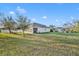 Expansive back yard featuring a screened patio, lush lawn and plenty of space for outdoor activities at 15506 Gemini Dr, Mascotte, FL 34753