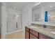 Bright bathroom with a glass shower stall and granite countertops on the vanity at 15506 Gemini Dr, Mascotte, FL 34753