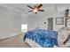 Comfortable bedroom featuring plush carpet, white walls, and a white ceiling fan at 15506 Gemini Dr, Mascotte, FL 34753