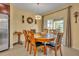 A cozy dining area features a wooden table set, chandelier, and a sliding glass door to the patio at 15506 Gemini Dr, Mascotte, FL 34753