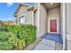 Close-up of a home's front door, showcasing the entryway, landscaping, and architectural details at 15506 Gemini Dr, Mascotte, FL 34753