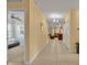 Spacious hallway connecting the bedroom and living areas, featuring tile floors and natural light at 15506 Gemini Dr, Mascotte, FL 34753