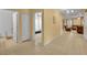 Bright hallway with tile flooring leading to a bedroom and living area, offering a spacious feel at 15506 Gemini Dr, Mascotte, FL 34753