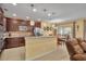 Well-lit kitchen featuring granite countertops, dark wood cabinets, and a breakfast bar at 15506 Gemini Dr, Mascotte, FL 34753