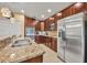 Kitchen view showcases granite countertops, stainless steel appliances, and ample cabinet space at 15506 Gemini Dr, Mascotte, FL 34753