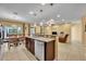 Kitchen view featuring tile floors, modern appliances, and an open floor plan to the living area at 15506 Gemini Dr, Mascotte, FL 34753