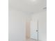 Clean, minimalist bedroom with a door, neutral walls, and modern recessed ceiling lighting at 1633 Sw 168Th Loop, Ocala, FL 34473