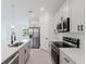 Well-lit modern kitchen features gray cabinets, stainless appliances, and gray tile flooring at 1633 Sw 168Th Loop, Ocala, FL 34473