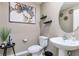 Half bathroom featuring modern fixtures, decor, and a well-lit space at 1703 Wynford Cir, Tavares, FL 32778