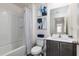 Bright bathroom with white vanity, framed mirror, modern fixtures, and shower-tub combination at 1703 Wynford Cir, Tavares, FL 32778