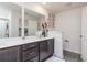 Bathroom featuring double sinks, white countertops and dark cabinets at 1703 Wynford Cir, Tavares, FL 32778