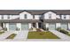 Townhome exterior featuring individual garages, landscaped front yards, and neutral color schemes for a modern aesthetic at 1703 Wynford Cir, Tavares, FL 32778