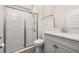 Bright bathroom featuring a white subway tile shower and gray vanity with granite countertops at 18339 Oliver Twist Way, Winter Garden, FL 34787