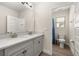 Bathroom with double vanity, granite countertop, and blue accents at 18339 Oliver Twist Way, Winter Garden, FL 34787