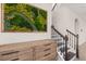 Elegant entryway with a decorative moss wall art piece and staircase with wrought iron spindles at 18339 Oliver Twist Way, Winter Garden, FL 34787