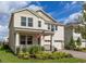 Charming two-story home with a well-manicured lawn, attached garage, and front porch at 18339 Oliver Twist Way, Winter Garden, FL 34787