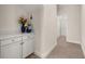 Hallway features white cabinetry and a light wood floor leading to a bathroom at 18339 Oliver Twist Way, Winter Garden, FL 34787