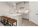 Bright kitchen features a center island with barstool seating, white cabinetry, and stainless steel appliances at 18339 Oliver Twist Way, Winter Garden, FL 34787
