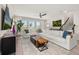 Inviting living room featuring a large white sectional sofa, stylish decor, and ample natural light at 18339 Oliver Twist Way, Winter Garden, FL 34787