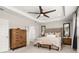 Serene primary bedroom with a tufted headboard, soft lighting, and a cozy sitting bench at 18339 Oliver Twist Way, Winter Garden, FL 34787