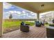 Outdoor patio with lounge chairs, grill, and view of green space offering a comfortable living space at 18339 Oliver Twist Way, Winter Garden, FL 34787