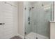 Modern shower with glass enclosure, rain shower head, and niche for toiletries at 18339 Oliver Twist Way, Winter Garden, FL 34787