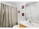 Bathroom featuring a shower with curtain, decorative accents, and ample counter space at 1909 Michigan Way, Poinciana, FL 34759