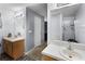 Bathroom featuring dual sinks, a shower, and a mirror with vanity lighting at 1909 Michigan Way, Poinciana, FL 34759