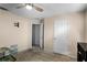 Bedroom featuring a ceiling fan, neutral walls, and an adjoining room at 1909 Michigan Way, Poinciana, FL 34759