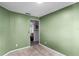 Bedroom featuring neutral carpet, green walls, and a door leading to another room at 1909 Michigan Way, Poinciana, FL 34759