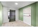 Bright bedroom featuring a window, built-in shelving, and a green accent wall at 1909 Michigan Way, Poinciana, FL 34759