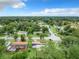 Aerial shot of the house showing its neighborhood, green lawns, and nearby streets at 23 Judith Ln, Orlando, FL 32811