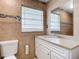 Bright bathroom with modern fixtures, a tiled wall, and vanity with sink at 23 Judith Ln, Orlando, FL 32811