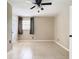 Large bedroom with tile floors, a ceiling fan and a door leading to another room at 23 Judith Ln, Orlando, FL 32811