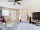 Bedroom with tile floors, ceiling fan, and multiple doors and windows at 23 Judith Ln, Orlando, FL 32811