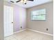 This bedroom features a window letting in lots of natural light and tile floors at 23 Judith Ln, Orlando, FL 32811