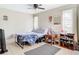 Cozy bedroom features neutral tones, a ceiling fan, and natural light from a window at 23 Judith Ln, Orlando, FL 32811