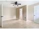 Spacious bedroom featuring tile floors, a ceiling fan, and neutral walls at 23 Judith Ln, Orlando, FL 32811