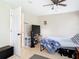 Bright bedroom with tile floors, a ceiling fan, and a door leading to another room at 23 Judith Ln, Orlando, FL 32811