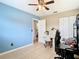 Bedroom with tiled floors, ceiling fan, and a calming blue accent wall at 23 Judith Ln, Orlando, FL 32811