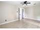 Bedroom showcasing neutral walls and flooring with ceiling fan and doorway views at 23 Judith Ln, Orlando, FL 32811