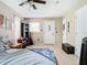 Bright bedroom featuring a ceiling fan, tile floors, and two entry doors at 23 Judith Ln, Orlando, FL 32811