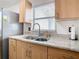 Kitchen area featuring stainless steel appliances, granite countertops, and natural light at 23 Judith Ln, Orlando, FL 32811