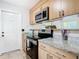 Updated kitchen featuring granite countertops, stainless steel appliances, and ample cabinet space at 23 Judith Ln, Orlando, FL 32811