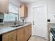 Well-lit kitchen featuring granite countertops and stainless steel faucet overlooking backyard at 23 Judith Ln, Orlando, FL 32811