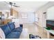 Bright living room with tile flooring, a ceiling fan, and an open layout to the kitchen at 23 Judith Ln, Orlando, FL 32811